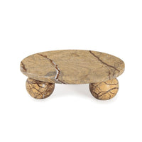 Marlow brown marble plate, 9" wide, with an oval top and two spherical legs.
