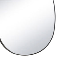 Mela Metal Mirror with a natural brass steel frame and unique organic silhouette.