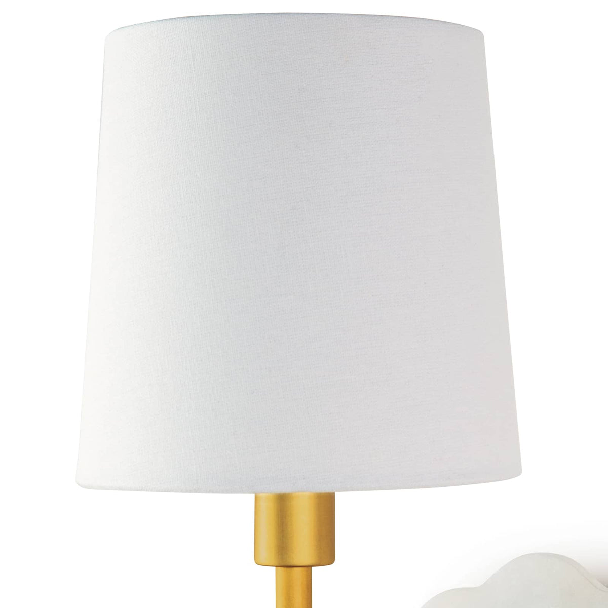 Mia swing arm sconce with white linen shade, natural brass arm, and scalloped alabaster backplate.