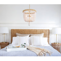 Milos White Beaded Chandelier with jute-wrapped frame, 25" H x 18" W, in a bedroom.