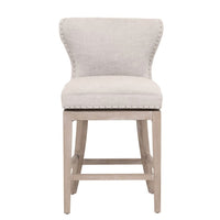 Milton Bisque French Linen swivel counter stool with transitional design, light wood legs, and nailhead trim.