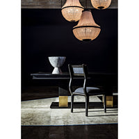 Black steel Mist Chandelier with beaded glass shades, illuminating a dining table and chair.