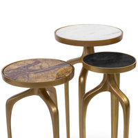 Set of three modern bronze mixer tables with round marble, black, and brown stone tops.