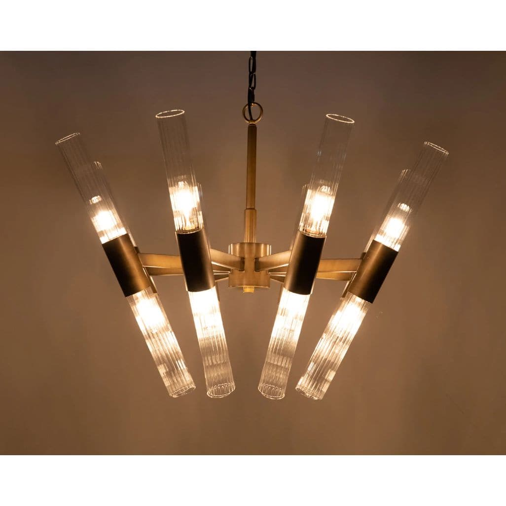 Moira Chandelier: Antique brass finish, industrial steel, and glass fixture with eight illuminated arms.