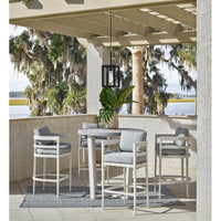 Montecito Black Outdoor Lantern with a bold charcoal frame and frosted glass, hanging over a patio bar set.