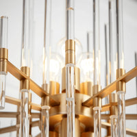 Small Montreal chandelier with aged brass finish and clear glass rods in a linear, geometric design.