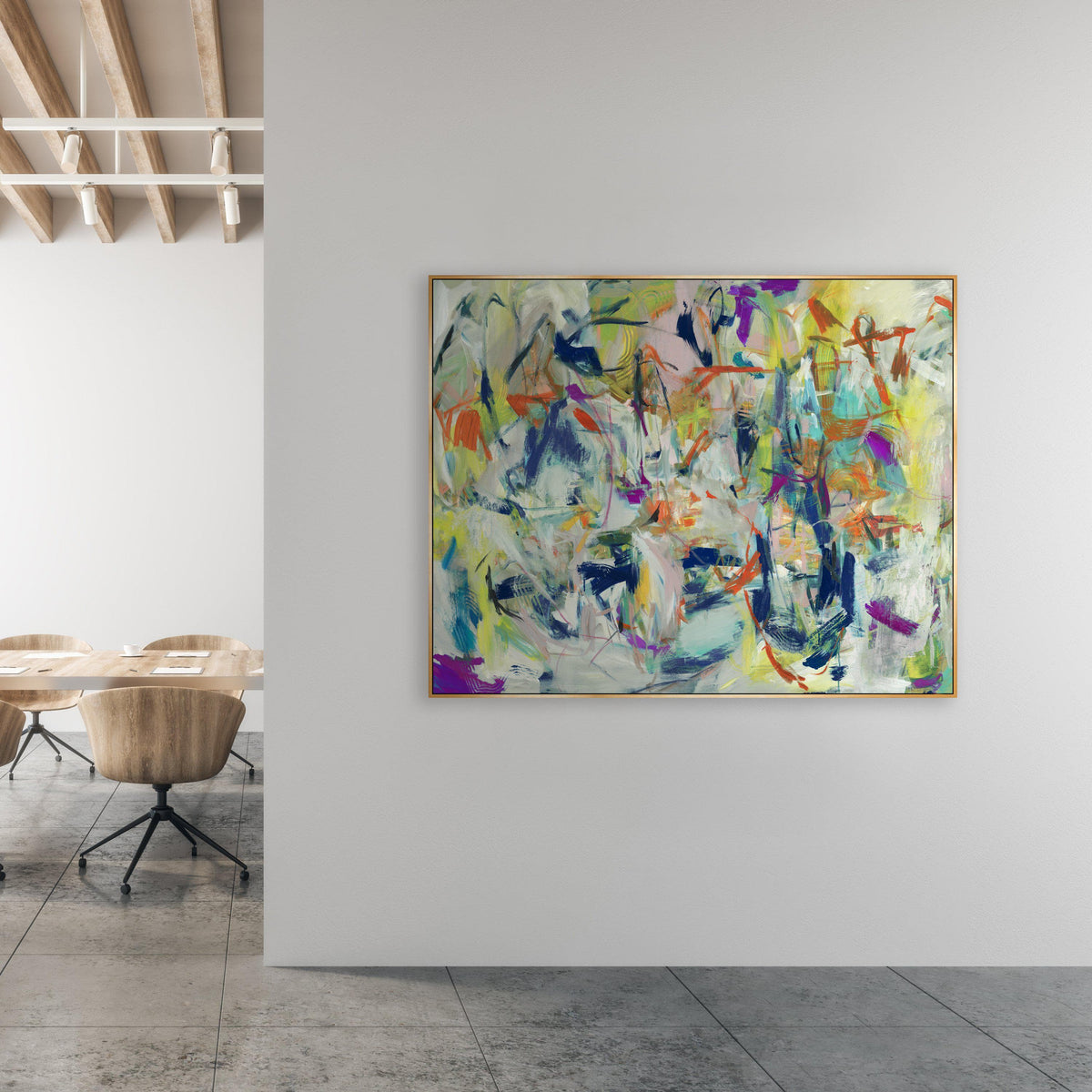 Abstract giclee canvas painting with vibrant colors and brush gel finish in a gold frame, displayed in a modern office.