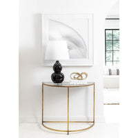 Myriad Infinity Gold Metal Sculpture on a console table, a continuous loop of solid brass.