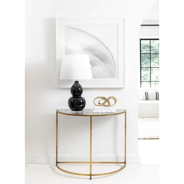 Myriad Infinity Gold Metal Sculpture on a console table, a continuous loop of solid brass.
