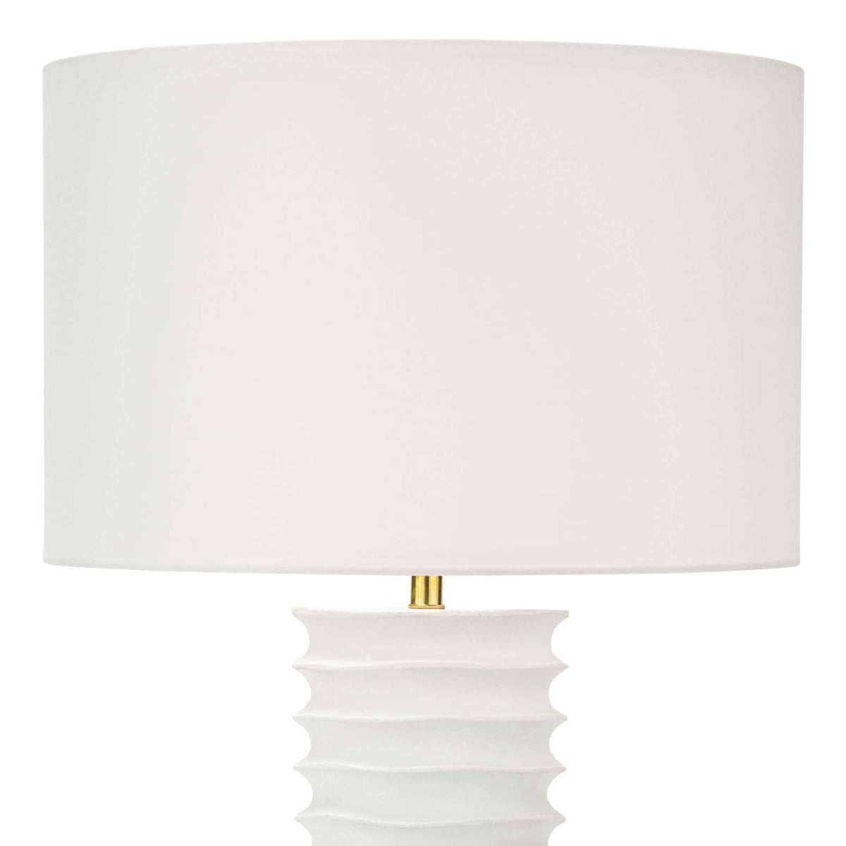 White Nabu metal column table lamp with accordion-like base and linen shade.