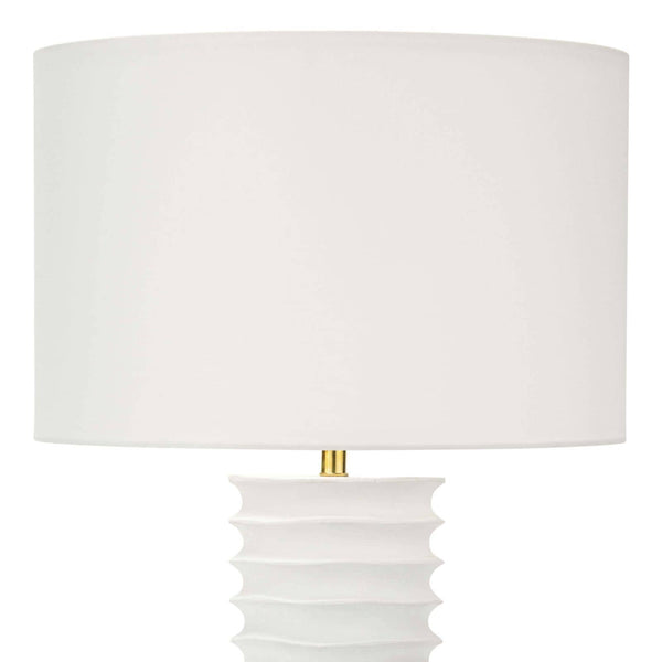 White Nabu metal column table lamp with accordion-like base and linen shade.