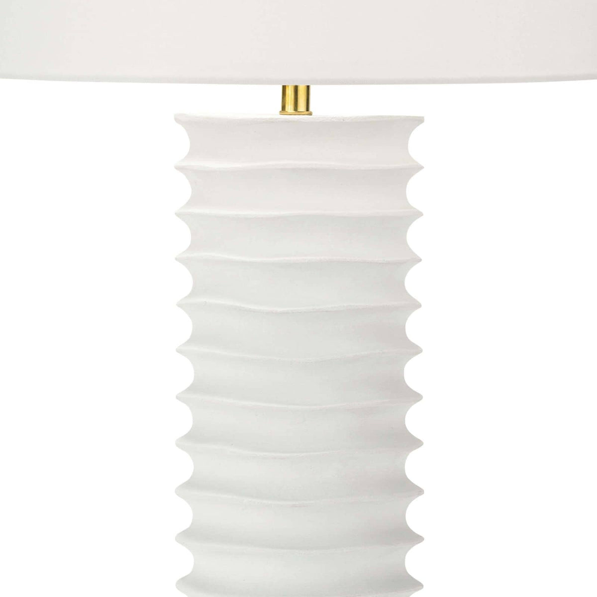 White Nabu metal column table lamp with an accordion-like base and a simple linen shade.