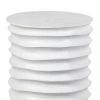 White Nabu Metal Table, drum-shaped aluminum with accordion-like texture and finger grooves.