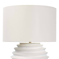 White Nabu metal table lamp with an accordion-like base and a simple linen shade.
