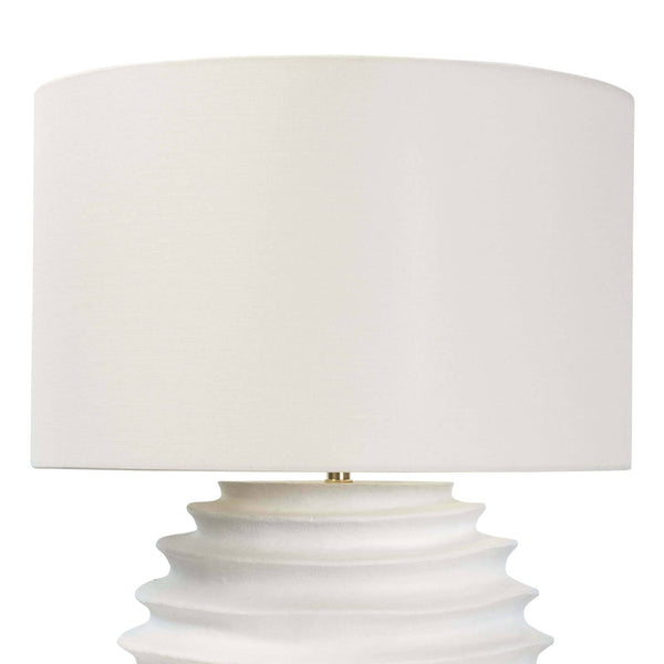 White Nabu metal table lamp with an accordion-like base and a simple linen shade.