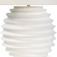 Nabu Metal Table Lamp with a tactile white accordion-like base and a simple linen shade.