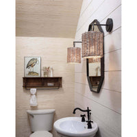 Nantucket sconce with a handwoven rattan shade and oil-rubbed bronze backplate, mounted above a mirror.