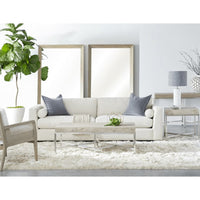 Two large natural gray acacia framed bevelled floor mirrors behind a white sofa in a living room.