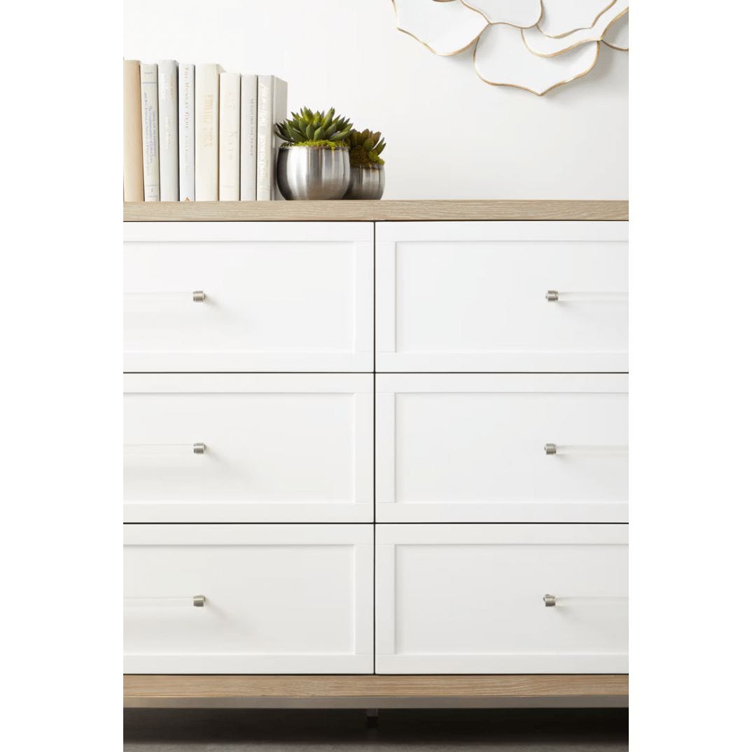 Natural gray wood dresser with 6 matte white drawers, clear acrylic handles, and stainless steel accents.