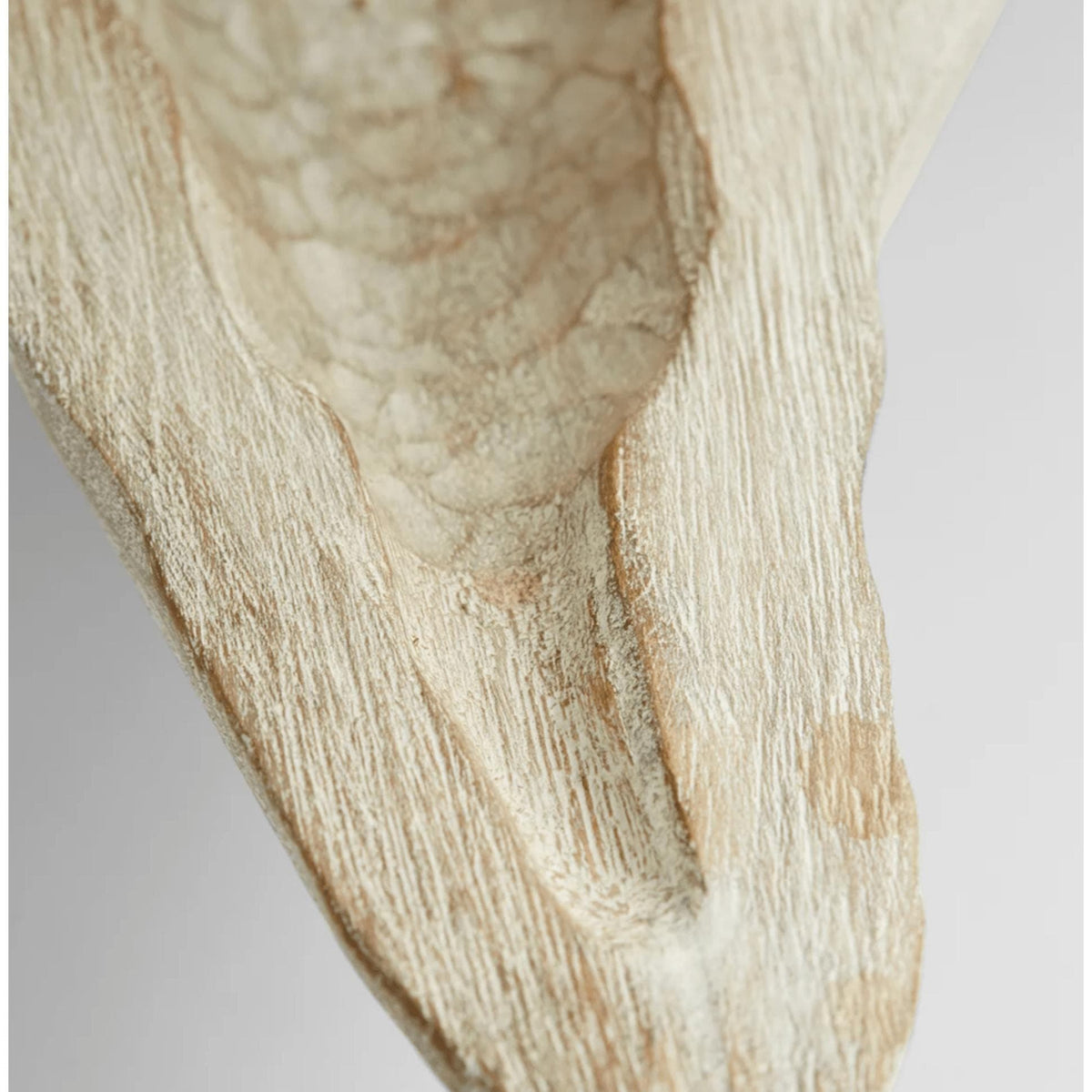 Close-up of a hand-carved Navarro whitewashed Ardu wood decorative tray, showing its unique texture.