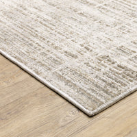 Nebulous Beige & Ivory Abstract Rug with a low-profile, textured polyester design on a light wood floor.
