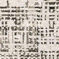 Abstract ivory and charcoal casual rug with a low-profile, textured polyester design.