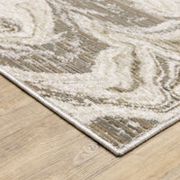 Contemporary ivory and grey swirl polyester rug with a low-profile texture on a wood floor.