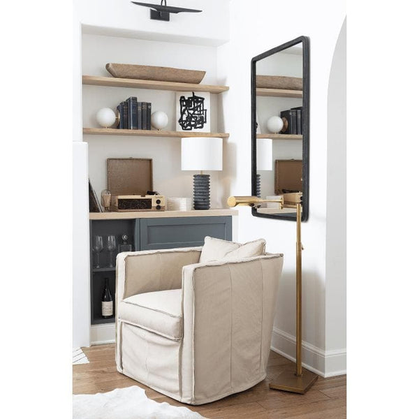 Noble Floor Task Reading Lamp in polished nickel with multiple pivoting joints, next to a beige armchair.