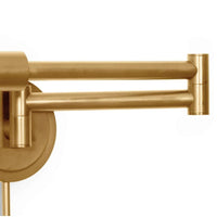 Noble Swing Arm Task Sconce in natural brass, featuring pivoting joints and a sleek metal design.