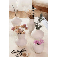Five organic white handmade ceramic vases, varying in size and shape, with dried flowers and greenery.
