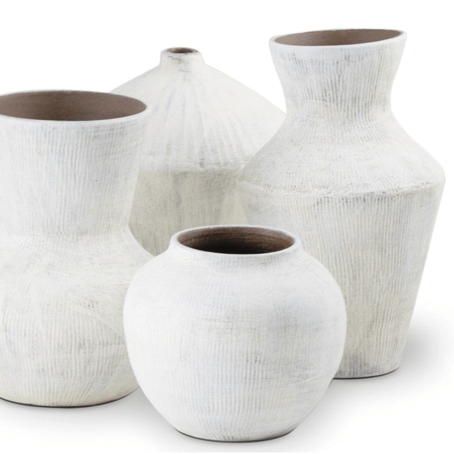 Set of four organic white ceramic vases with handmade textured details and varying shapes.