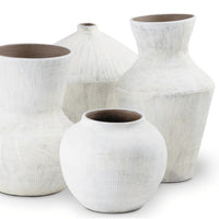 Set of four organic white ceramic vases with handmade textured details and varying shapes.