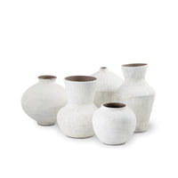 Noor Ceramic Vase Set: Five handmade organic white vases with unique textures and brown interiors.