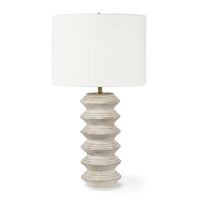 Nova Wood Table Lamp with white-washed carved wood body, natural linen drum shade, and brass finial.
