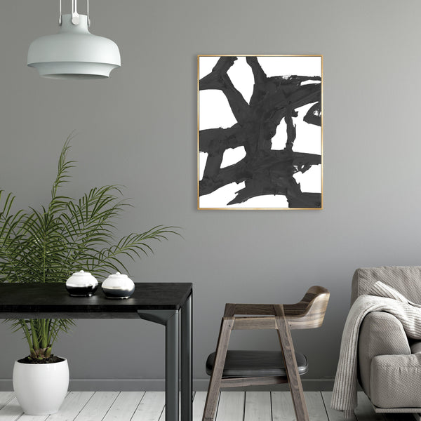 Obsidian III Giclee Canvas Painting: Abstract black brushstrokes on white, framed in gold, in a modern interior.