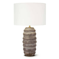 Ola ceramic table lamp with an organic, wavy earthenware base in earthen brown and tan, topped with a natural linen drum shade.