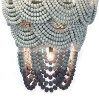 Ombre wood bead chandelier with blue gradient layers, jute-wrapped frame, and exposed candelabra bulbs.