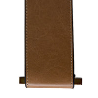 Brown leather strap with white stitching and brass hardware.