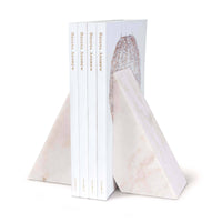 White marble Othello bookends with a sleek, mod design, holding four books.