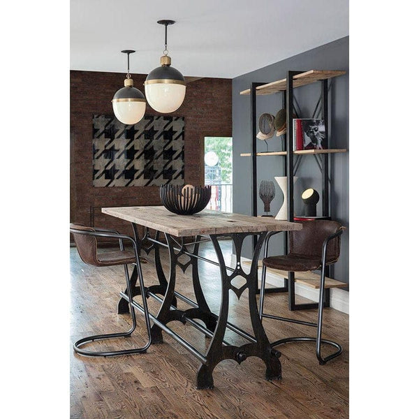 Large Otis pendant with blackened natural brass and translucent white milk glass, hanging over a dining table.