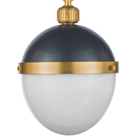 Otis pendant with a blackened brass dome, natural brass band, and white milk glass globe.