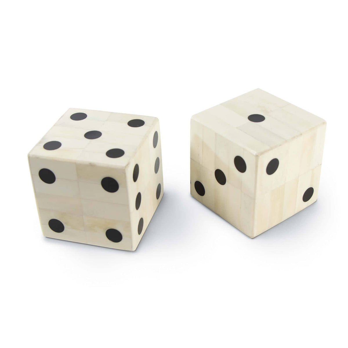 Pair of oversized, off-white bone dice with inlaid black dots, featuring a mosaic-like texture.