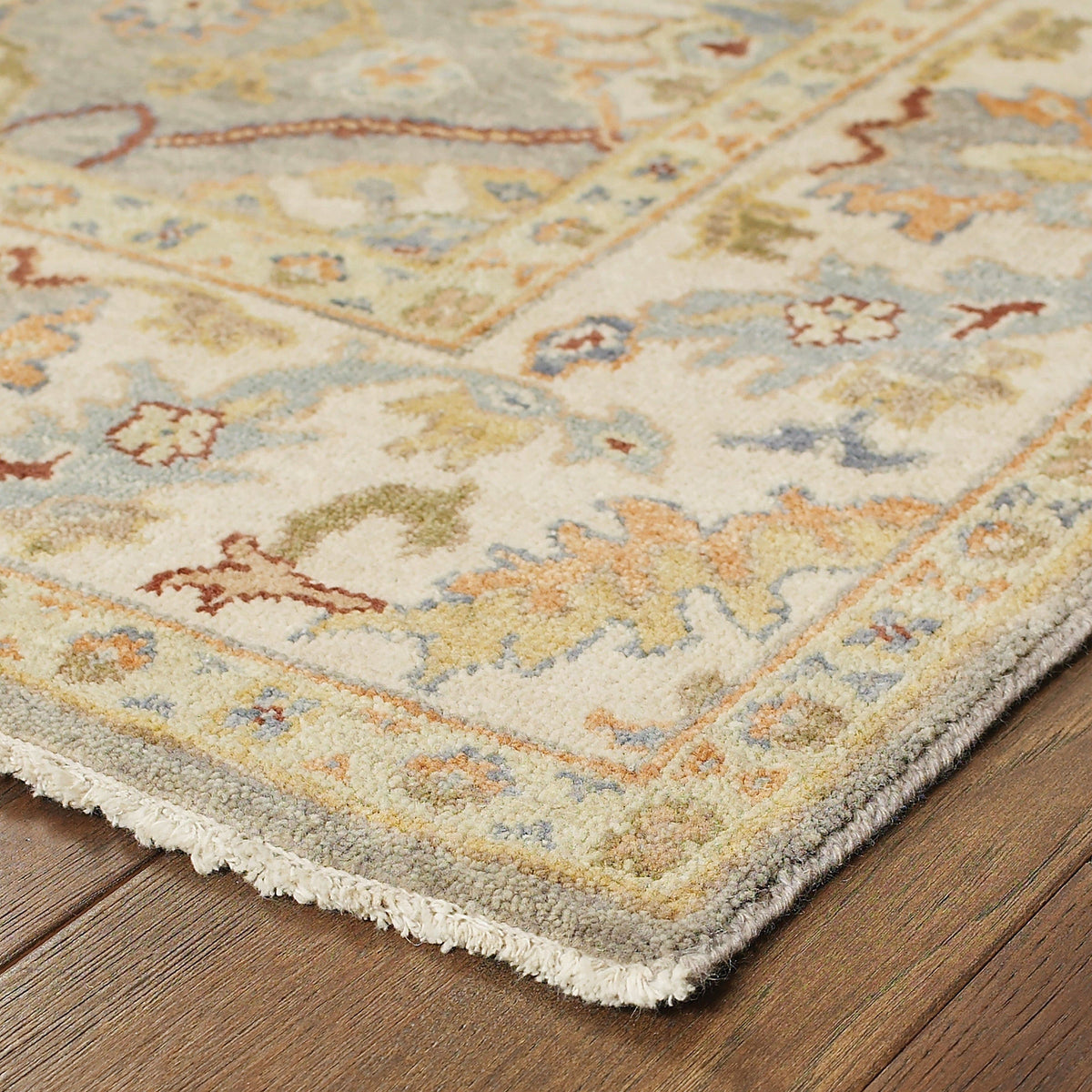 Hand-knotted Palace Grey & Beige Traditional Wool Rug with classic Oushak patterns on a wood floor.