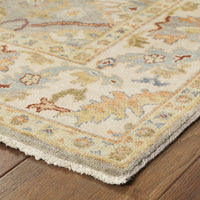 Hand-knotted Palace Grey & Beige Traditional Wool Rug with classic Oushak patterns on a wood floor.