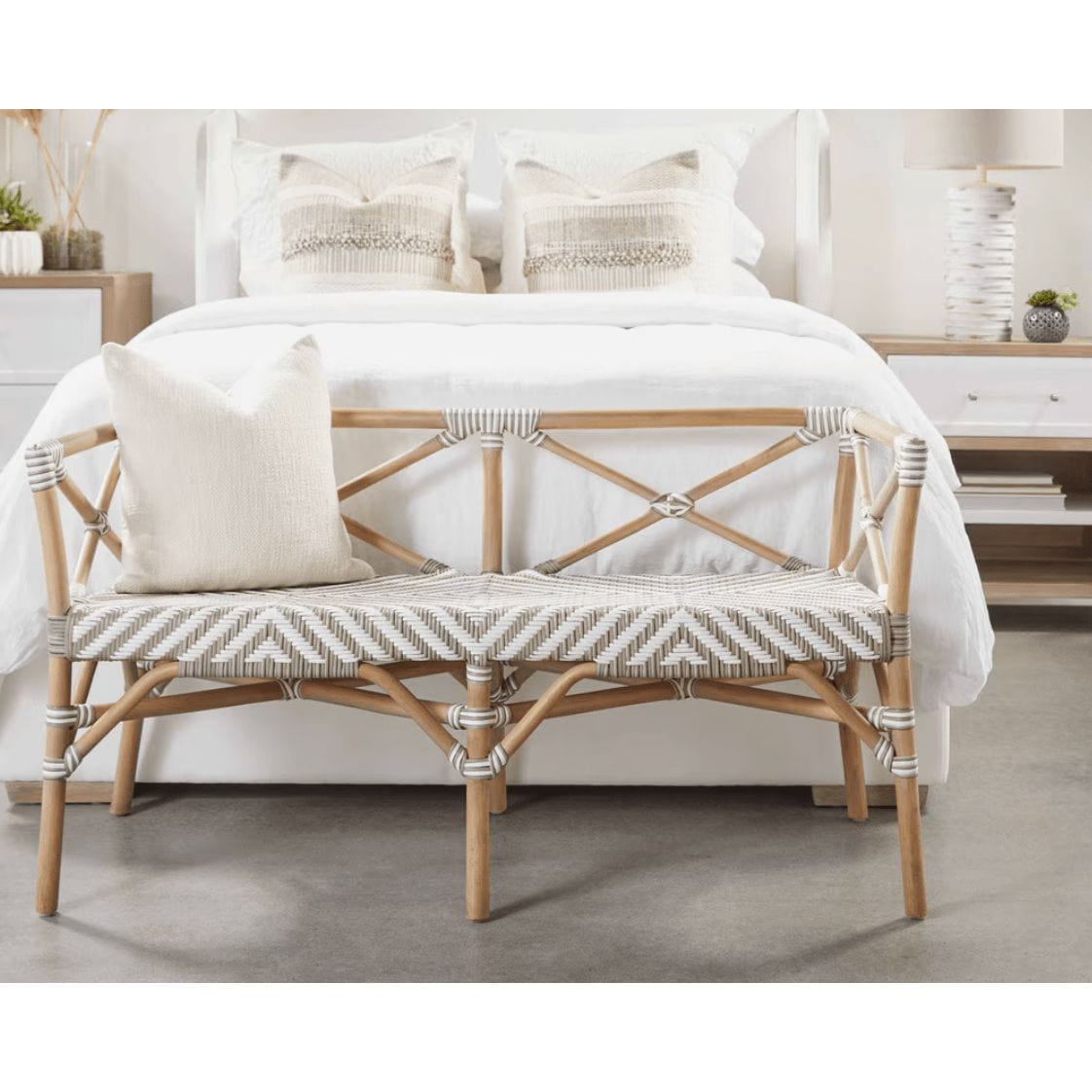 Coastal Palisades natural rattan bench with white and beige chevron woven seat and X-back design.