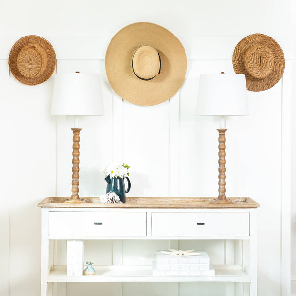Natural Perennial Buffet Lamps with white linen shades on a white console table with coastal decor.