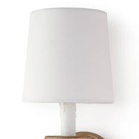 Natural wood Perennial sconce with a white linen shade and faux drip wax candle sleeve for rustic coastal style.