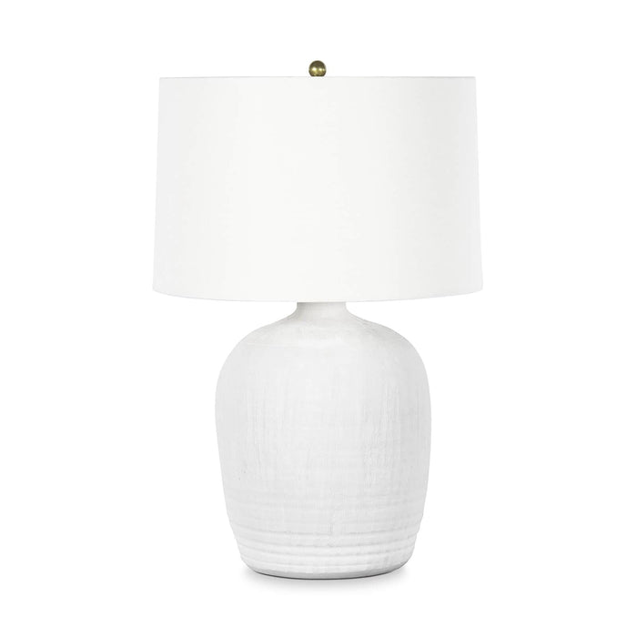 Matte white textured ceramic table lamp with natural brass hardware and a white linen shade.