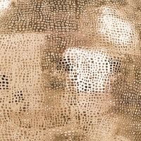 Close-up of a natural brass pierced metal sphere pendant with an organic perforated design.