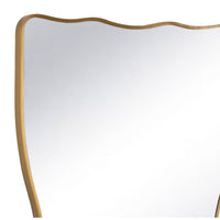 Piero Metal Mirror with a natural brass, ribbon-shaped frame and wavy top edge.